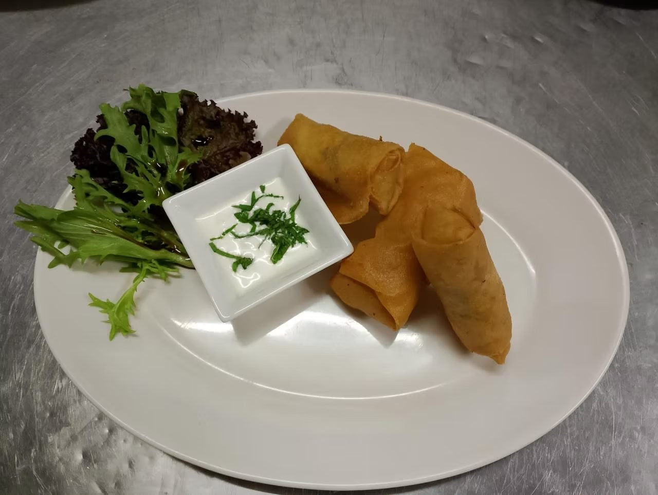 Crispy vegetable samosa with mint dip at The Dining Room Candidasa